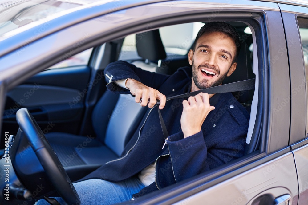 Young hispanic man smiling confident wearing car belt at street