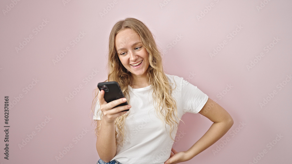 Young blonde woman using smartphone smiling over isolated pink background Young blonde woman using smartphone smiling over isolated pink background
