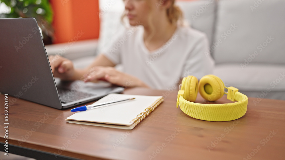 Young blonde woman using laptop sitting on floor at home Young blonde woman using laptop sitting on floor at home