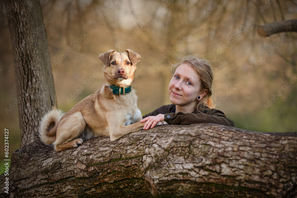 Portrait of beautiful blonde girl with a dog