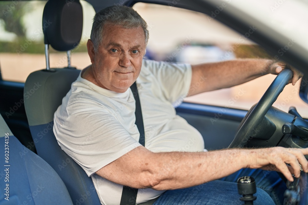 Middle age grey-haired man smiling confident driving car at street Middle age grey-haired man smiling confident driving car at street