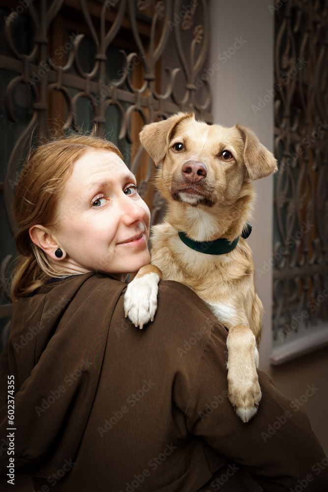 Portrait of beautiful blonde girl with a dog