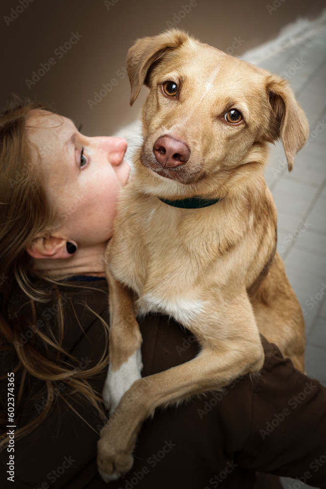 Portrait of beautiful blonde girl with a dog
