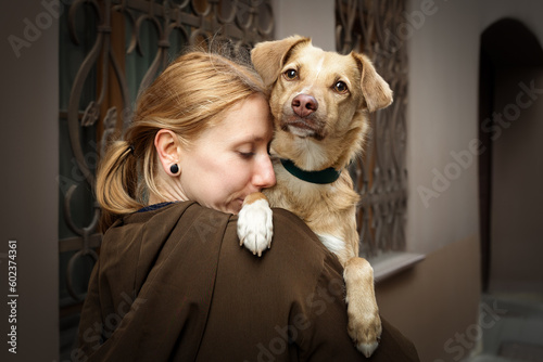 Portrait of beautiful blonde girl with a dog