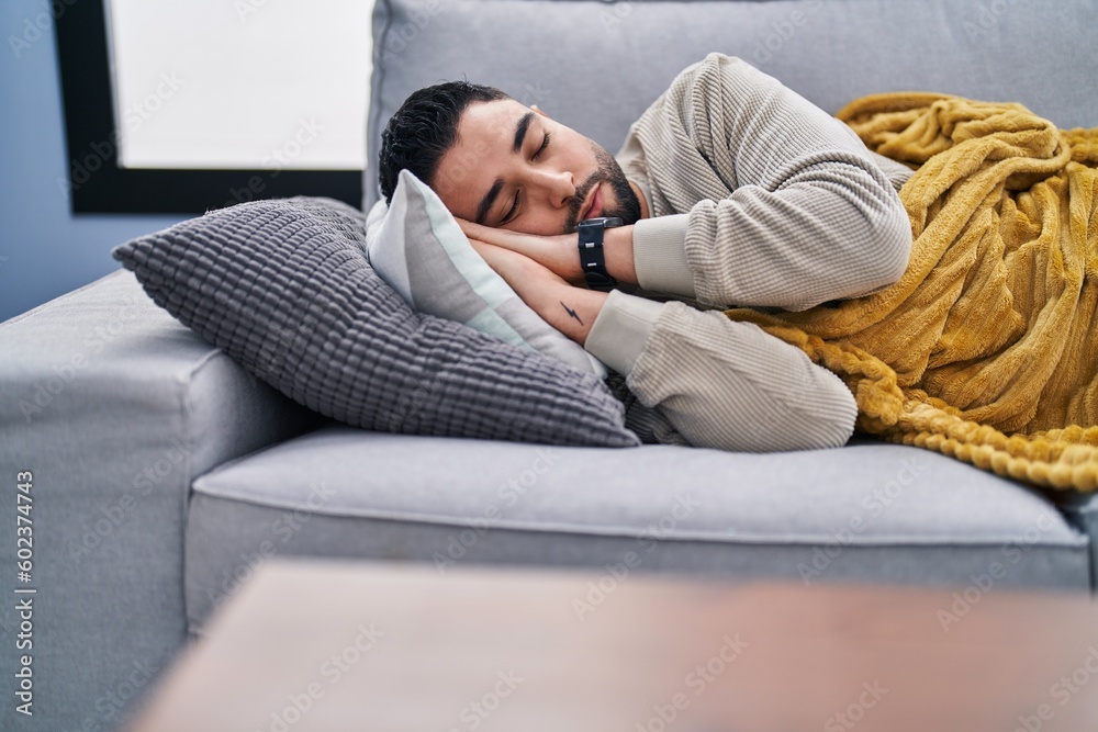 Young arab man lying on sofa sleeping at home Young arab man lying on sofa sleeping at home