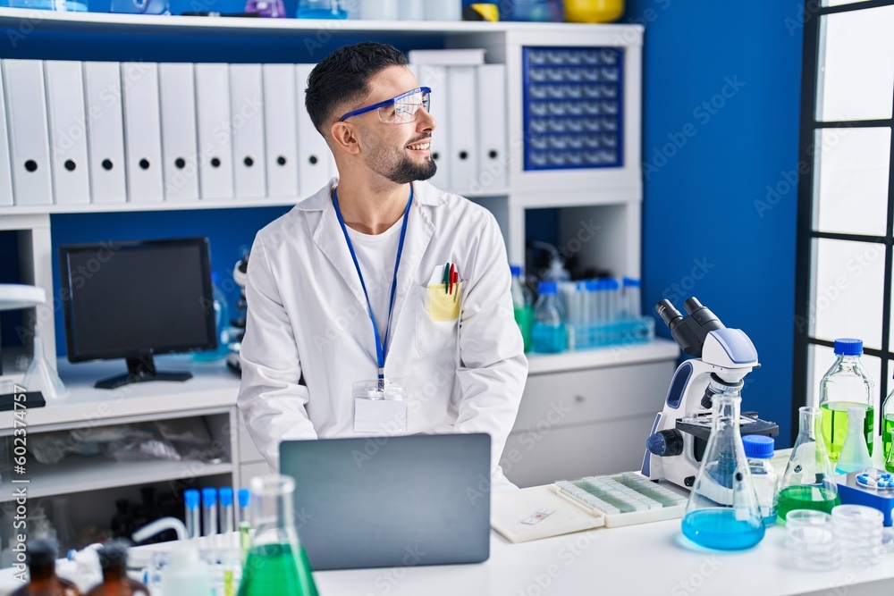 Young arab man scientist using laptop working at laboratory Young arab man scientist using laptop working at laboratory