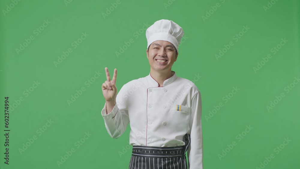 Asian Man Chef Smiling And Showing Peace Gesture To Camera While Standing In The Green Screen Background Studio
Asian Man Chef Smiling And Showing Peace Gesture To Camera While Standing In The Green Screen Background Studio