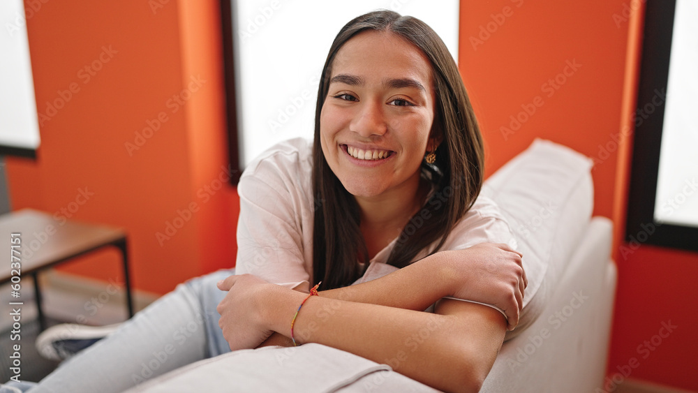 Young beautiful hispanic woman smiling confident sitting on sofa at home Young beautiful hispanic woman smiling confident sitting on sofa at home