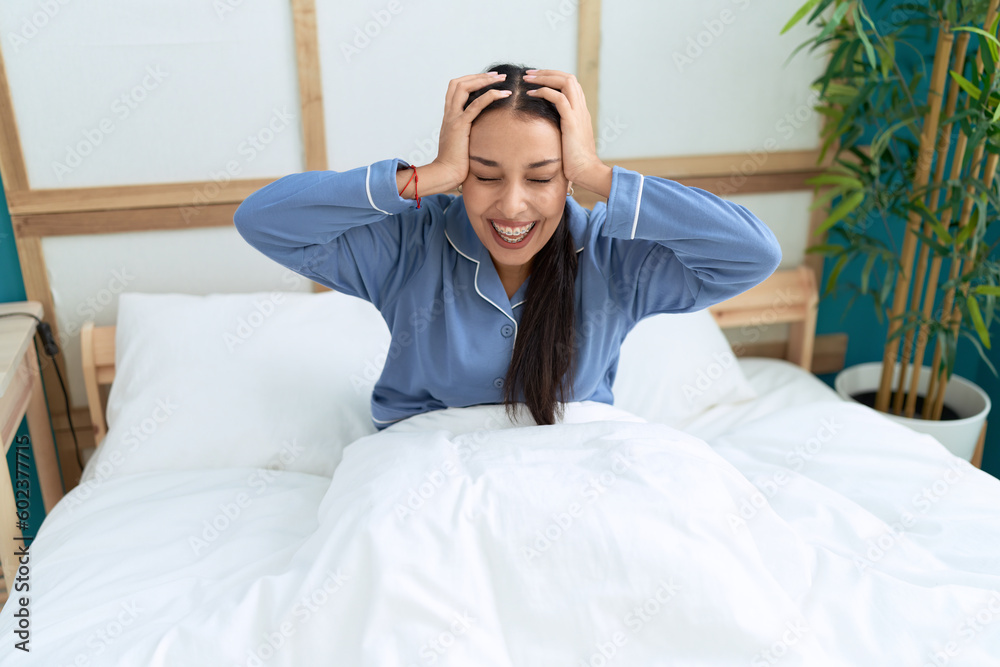 Obraz premium Young arab woman stressed sitting on bed at bedroom