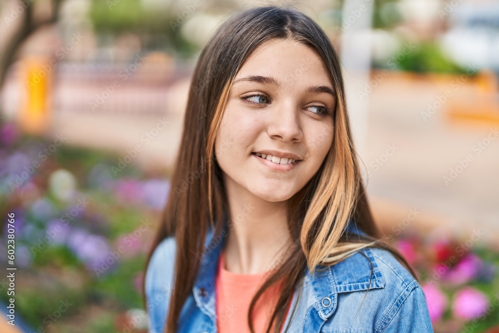 Adorable girl smiling confident looking to the side at park Adorable girl smiling confident looking to the side at park