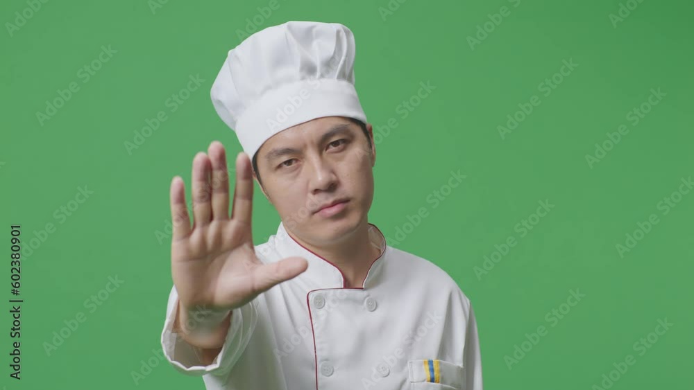 Close Up Of Asian Man Chef Looking At Camera And Disapproving With No Hand Sign In The Green Screen Background Studio
Close Up Of Asian Man Chef Looking At Camera And Disapproving With No Hand Sign In The Green Screen Background Studio