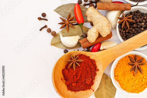 Powder, table top and food spices in studio isolated on white background mock up. Turmeric seasoning, kitchen cooking and variety of leaf herbs in bowls for brunch, healthy diet and paprika in spoon.