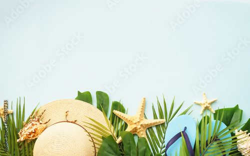 Summer vacation and travel concept. Palm leaves, hat, flip flop and sunglasses on white background. Flat lay with copy space.