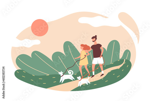 Young couple walking their dogs outdoors. People performing summer outdoor activities.