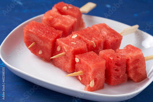 Finger food sticks with with watermelon cubes.