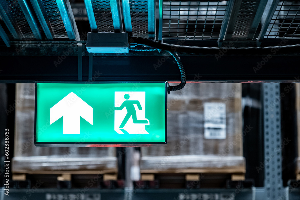 Emergency exit sign or fire exit sign hanging on rack structure in