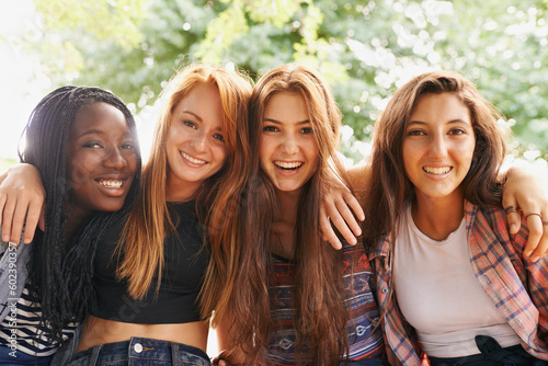 Girl friends, happy hug and portrait outdoor with diversity in group on holiday summer camp. Female student, sunshine and happiness face of young gen z and teen people together on vacation break photo