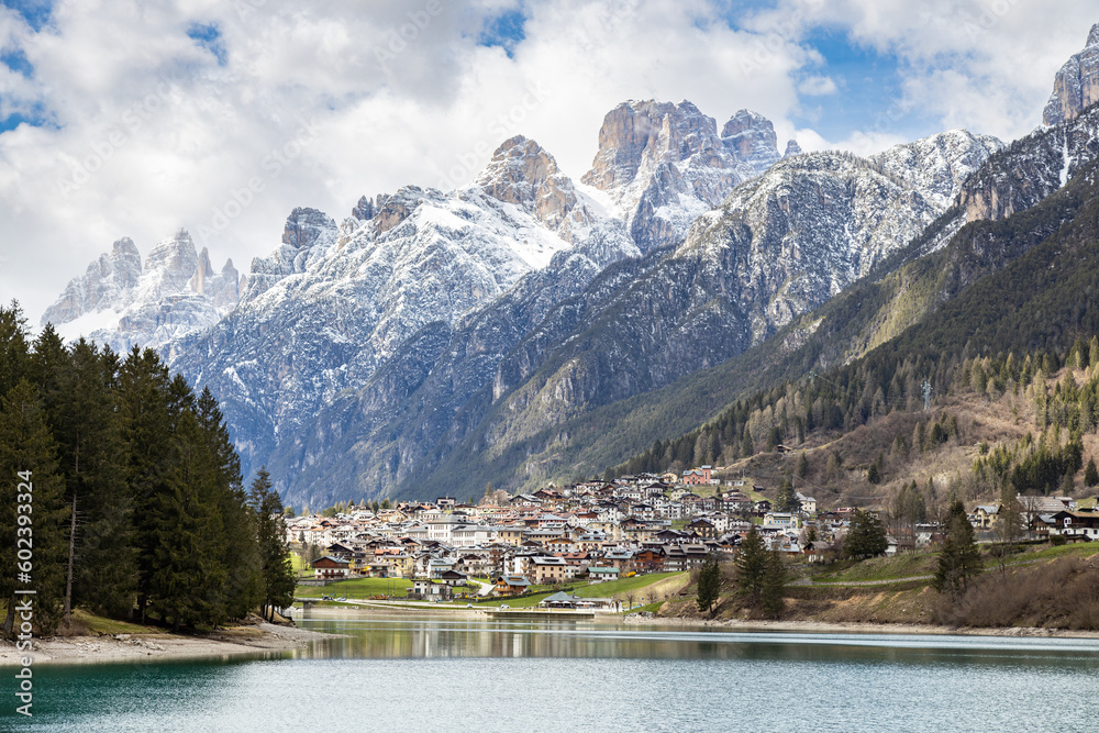 Beautiful view of Auronzo Lake, in Auronzo di Cadore village; Snow peaked mountains on background; Belluno, Dolomites, Italy