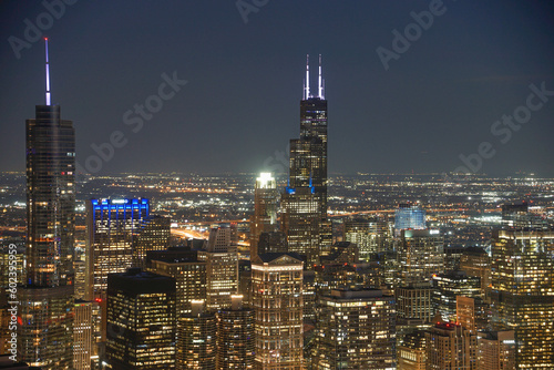 Downtown Chicago skyscrapers illuminated at night with endless citylights in the background