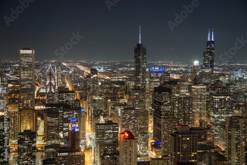 Downtown Chicago skyscrapers illuminated at night with endless citylights in the background