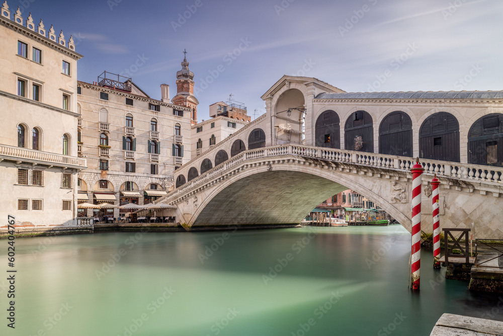 Rialto Bridge and the Grand Canal Venice Italy. Sunny day long exposure has smoothed the canal. No people in the photograph of this famous Venetian landmark. 