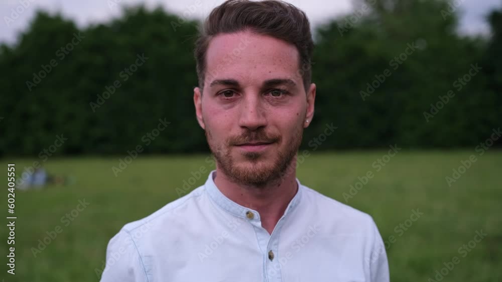 Video of young man smiling in a close-up outdoors at sunset. Concept: Lifestyle, smile, fun Video of young man smiling in a close-up outdoors at sunset. Concept: Lifestyle, smile, fun