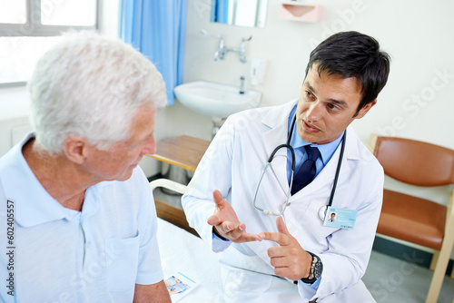 Doctor  senior man patient and talk with information  results and news with consulting health in retirement at clinic. Men  medic and consultation for wellness  healthcare and discussion in hospital
