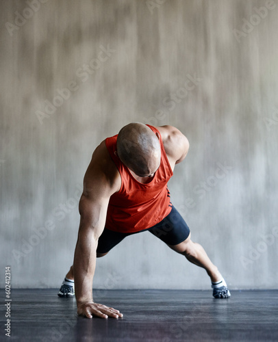 Strong man, floor and one arm push up for gym studio exercise, bodybuilder workout or sports training. Fitness club motivation, endurance mockup and male athlete doing floor pushup for health goals
