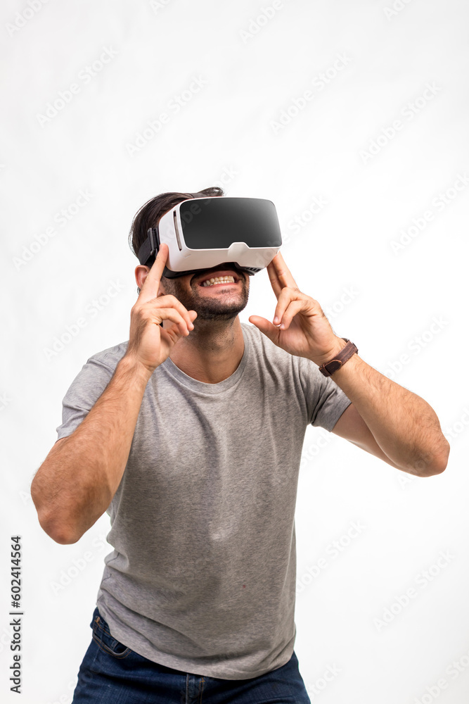 Naklejka premium Man in VR headset. Man using VR glasses for online game. Handsome man using virtual reality headset. man experience virtual reality via VR headset and touching something with hands.