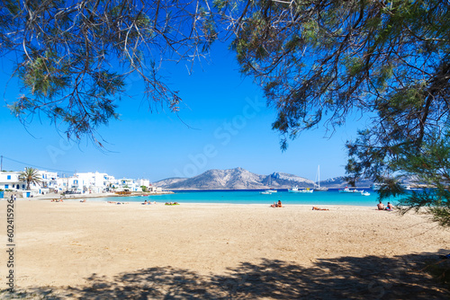 Beautiful beach of Ammos framed with tree branches, in Chora village, the only settlment at Koufonisi island, in Cyclades islands, Greece, Europe. © YiannisMantas