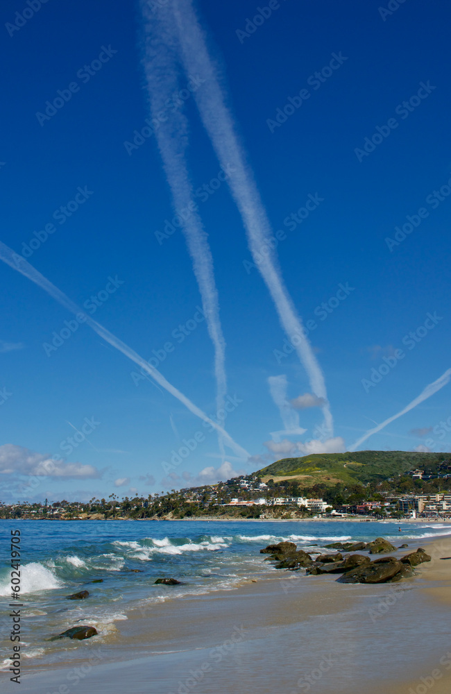 dramatic cloudscape with contrails across the coast