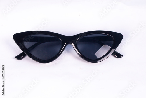 black glasses with elongated corners. sun protection sunglasses. black glass isolated on white background