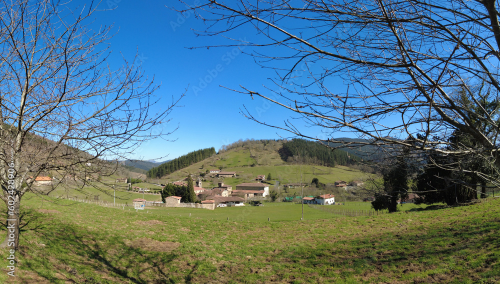 Obraz premium The small village of Axpe surrounded by green fields in Atxondo valley in the Basque Country, Spain
