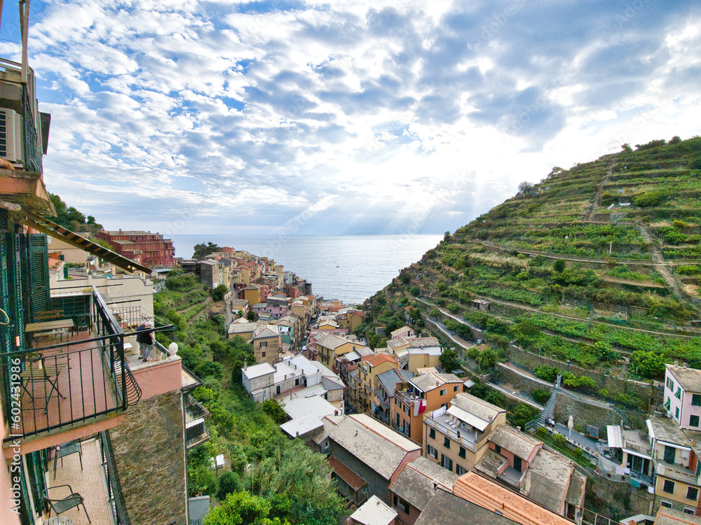 Daytime view from the top of Manarola, Italy with rays of light over the ocean