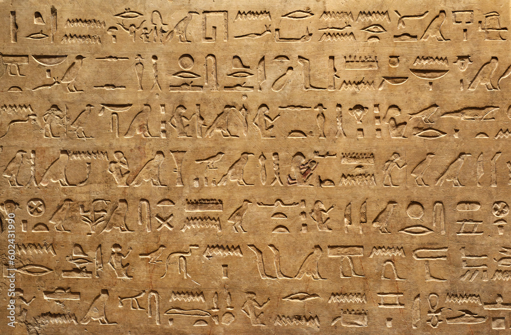 Old Egyptian hieroglyphs on an ancient background. Wide historical background. Ancient Egyptian hieroglyphs as a symbol of the history of the Earth. - obrazy, fototapety, plakaty 