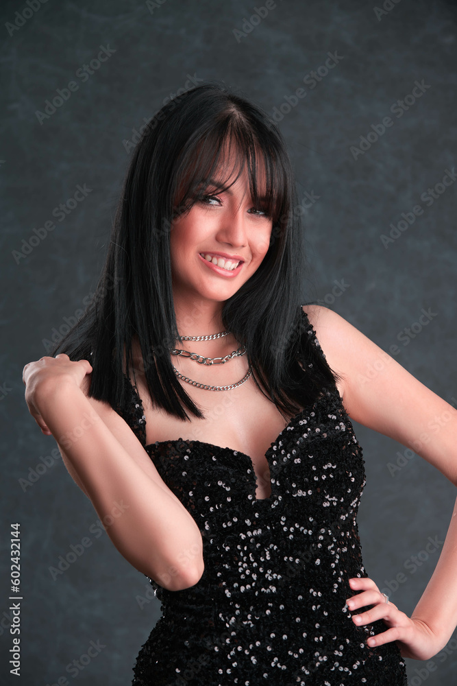 Caucasian beauty stuns in black sequin party dress against dark background in sleek, modern fashion shoot Caucasian beauty stuns in black sequin party dress against dark background in sleek, modern fashion shoot
