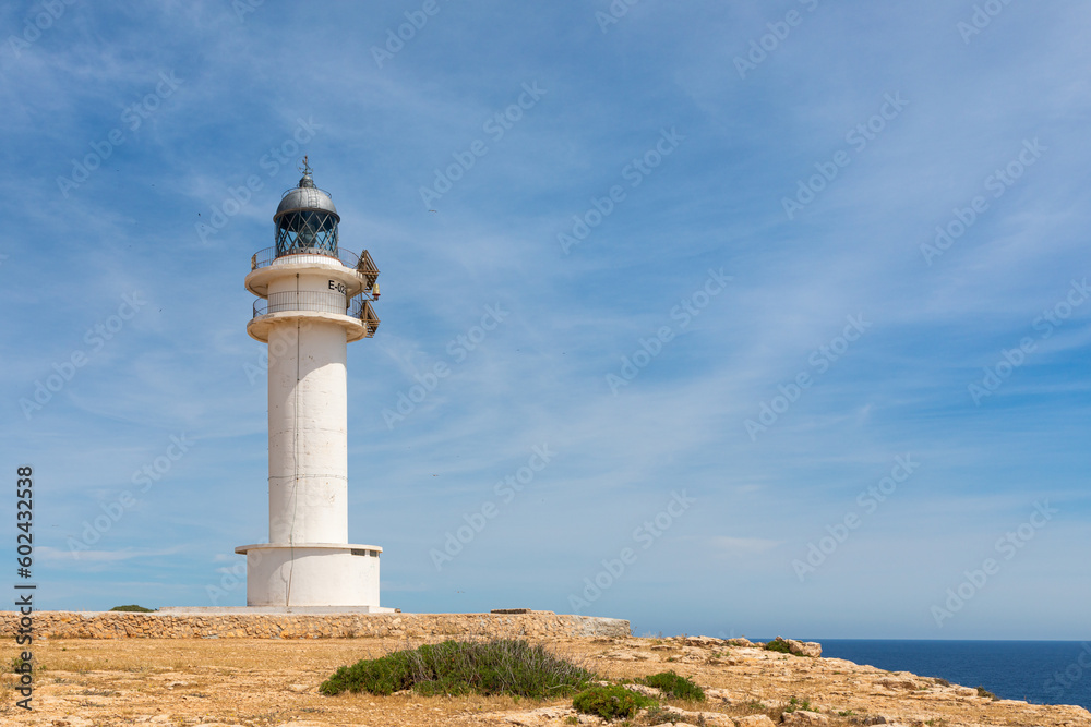 Formentera: Cape Barbaria lighthouse at the edge of the cliffs and the Mediterranean Sea