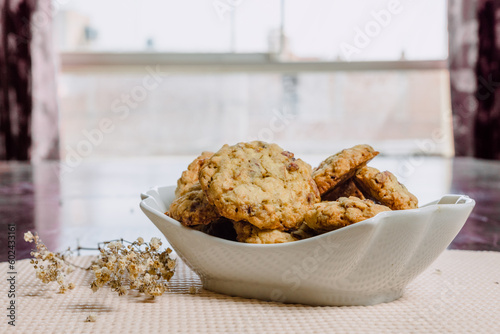 Pumpkin, oat cookies with cranberries, almond on a bowl in a kitchen.