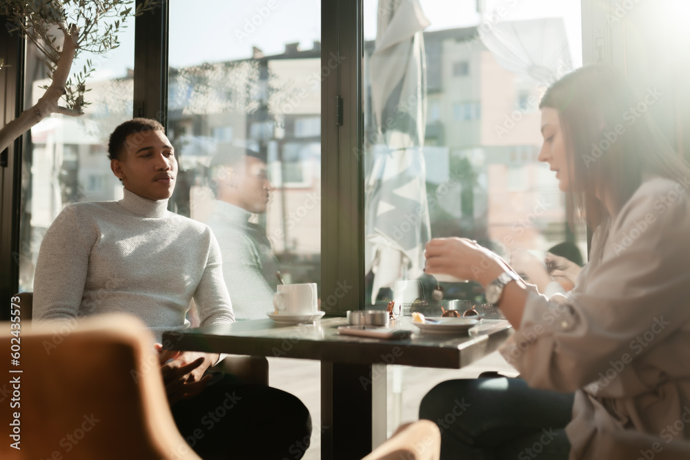 Friends in a restaurant talking smiling and drinking tea. Business colleagues having a meeting after work or during coffee break at a cafe bar.. Friends in a restaurant talking smiling and drinking tea. Business colleagues having a meeting after work or during coffee break at a cafe bar..