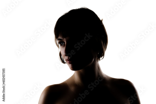 silhouette studio portrait of a beautiful brunette girl with short hair against white background.
