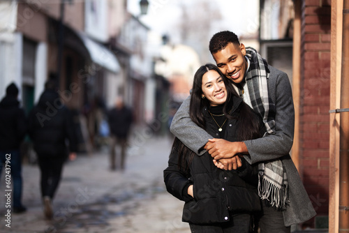 Multiracial couple posing on narrow streets in old part of the sity. Old turkish bazaar in Skopje, North Macedonia.