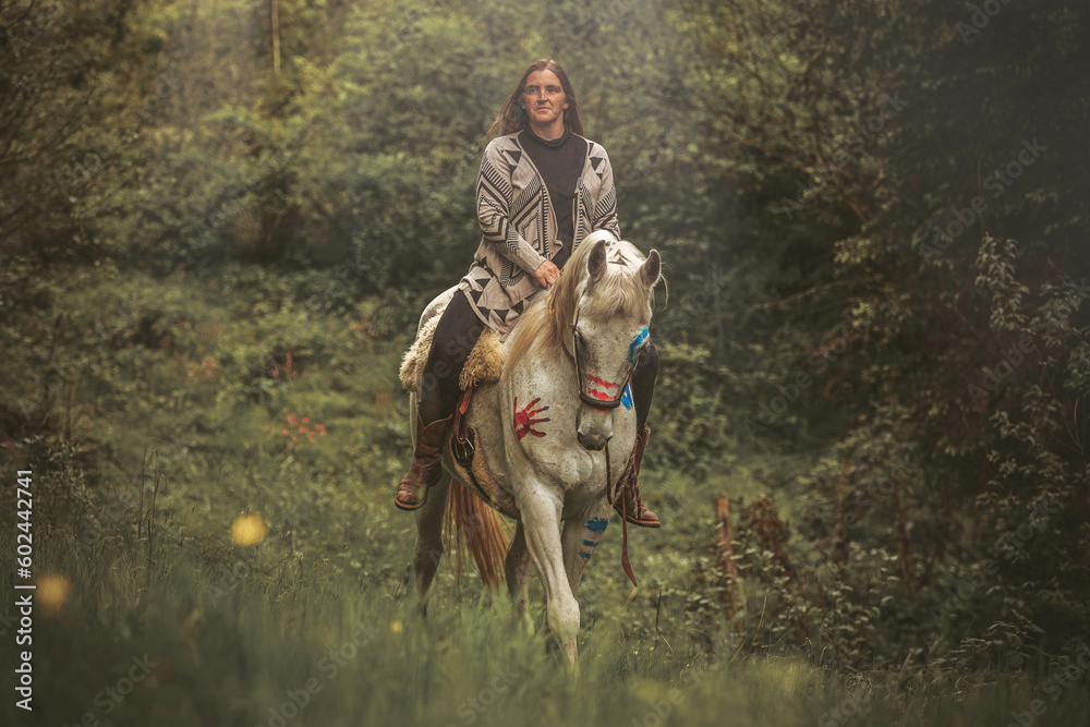 Portrait of a woman on her american native decorated white arabian horse in spring outdoors Portrait of a woman on her american native decorated white arabian horse in spring outdoors