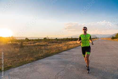 Triathlete in professional gear running early in the morning, preparing for a marathon, dedication to sport and readiness to take on the challenges of a marathon. 