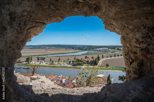 Blurred wall slit with aerial view over Sado river and roofs of downtown houses, Alcácer do Sal, Setúbal PORTUGAL