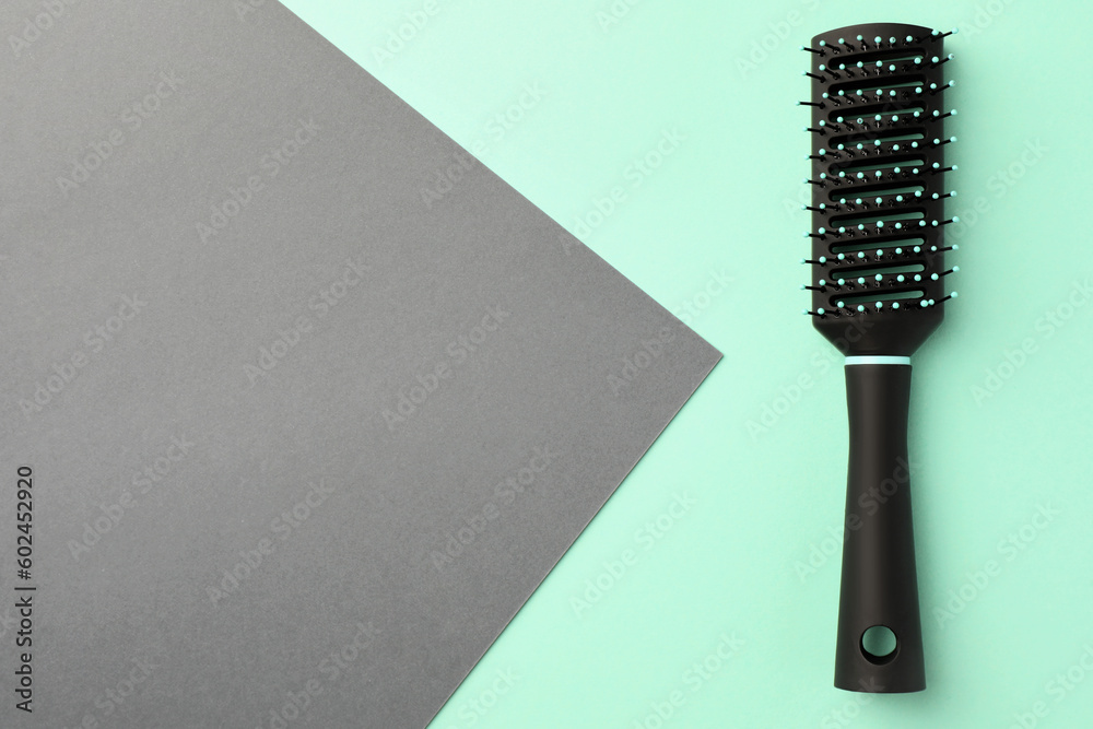 Fototapeta premium Stylish hairbrush on color background, top view. Space for text