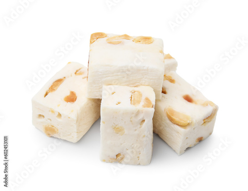 Many pieces of delicious nougat on white background