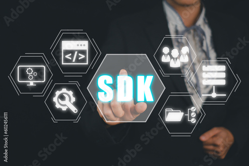 SDK - Software development kit programming language technology concept, Business woman hand touching SDK icon on virtual screen.