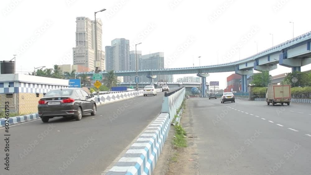 14th May, 2023, Kolklata, West Bengal, India: Early morning traffic movement on Eastern Metropolitan Bypass and Maa bridge with beautiful cityscape of Kolkata. 14th May, 2023, Kolklata, West Bengal, India: Early morning traffic movement on Eastern Metropolitan Bypass and Maa bridge with beautiful cityscape of Kolkata.
