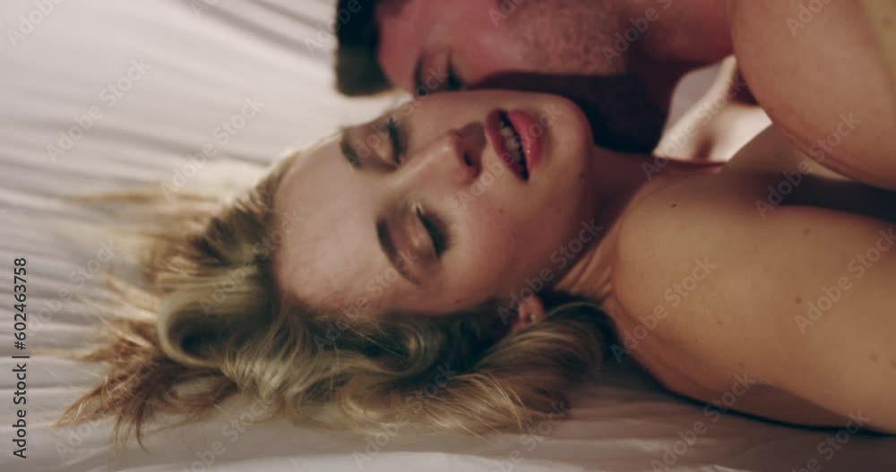 Sexy couple, bedroom and kissing for foreplay in a house, apartment or hotel. Man and woman together on bed while intimate, making love or sex for passion, affection and lust or erotic experience