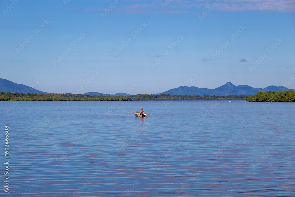 Aerial view of the city of Cananéia. Mangrove and sea in Ilha do Cardoso State Park. With man fishing in a boat